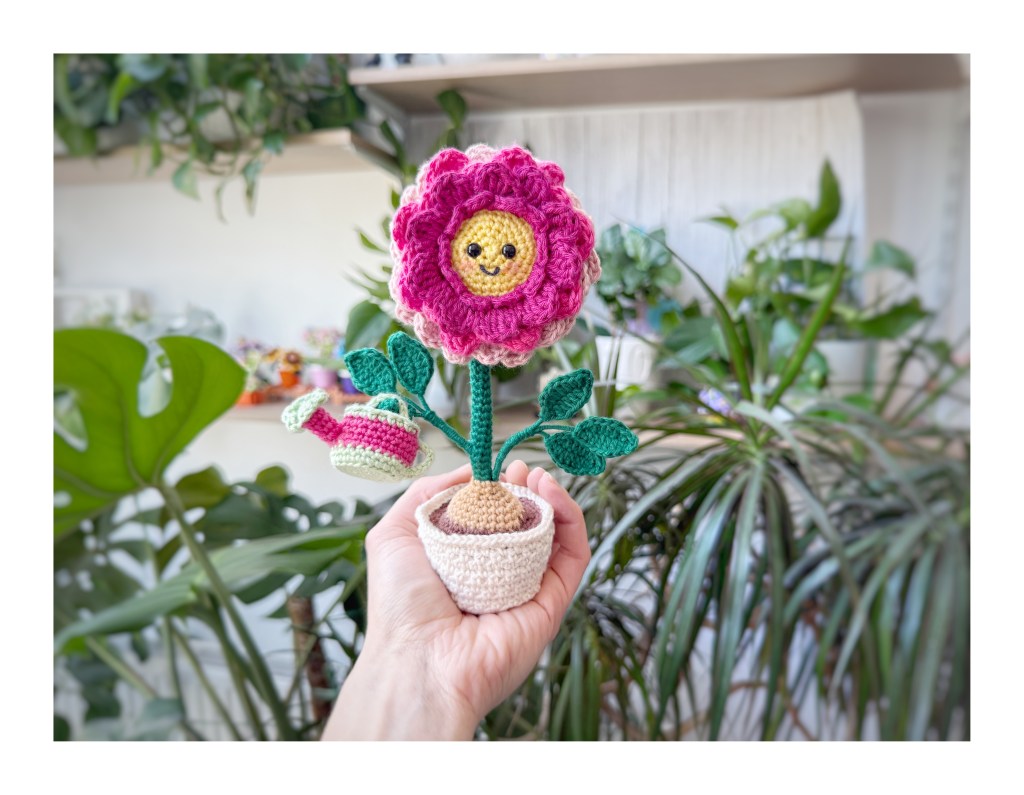 crochet dahlia in a flower pot with a watering can